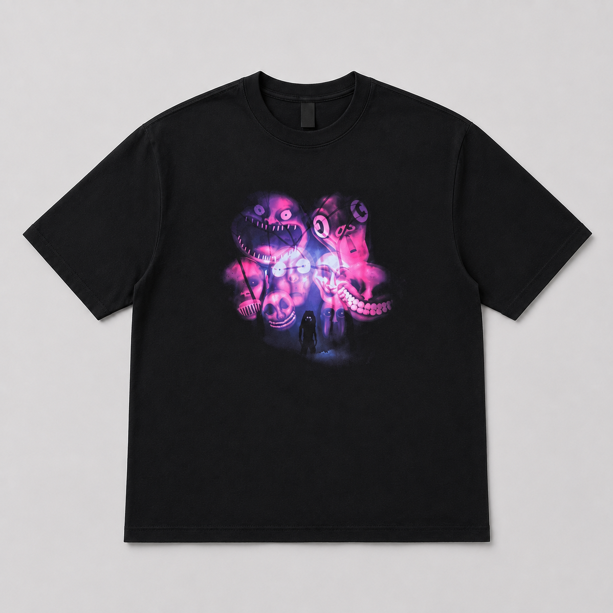 A black short-sleeve crewneck t-shirt featuring a colorful graphic print of a creepy, smiling monster face with glowing pink and purple details, displayed flat against a neutral gray background.