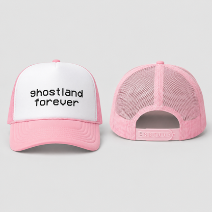 A pink and white trucker hat shown from the front and back on a light gray background. The front panel is white with the text 'ghostland forever' in black lowercase letters, and the brim and mesh back are pink.